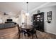 Open dining area with dark wood table and chairs, with the living room in the background at 15591 Heatherbank Dr, Westfield, IN 46074