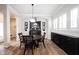 Dining room with wood floors features a round table, black hutch and sideboard with wine rack at 15591 Heatherbank Dr, Westfield, IN 46074