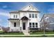 A beautiful two-story home with a charming front porch, stone accents, and a well-maintained lawn at 15591 Heatherbank Dr, Westfield, IN 46074