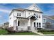 Charming two-story home with a welcoming front porch, crisp white siding, and well-manicured landscaping at 15591 Heatherbank Dr, Westfield, IN 46074