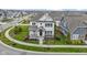 Gorgeous two-story home featuring a welcoming front porch, beautiful landscaping, and a serene neighborhood setting at 15591 Heatherbank Dr, Westfield, IN 46074