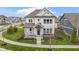 Beautiful two-story home boasting a charming front porch, manicured lawn, and modern architectural design at 15591 Heatherbank Dr, Westfield, IN 46074