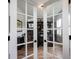 Home office with glass French doors, custom bookshelves, and an elegant desk for a productive workspace at 15591 Heatherbank Dr, Westfield, IN 46074