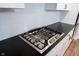 Stainless steel gas range on a granite countertop with white subway tile backsplash at 15591 Heatherbank Dr, Westfield, IN 46074