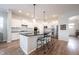 Bright, modern kitchen with white cabinetry, black countertops, and stainless appliances at 15591 Heatherbank Dr, Westfield, IN 46074