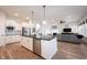 Open concept kitchen featuring white cabinetry, stainless steel appliances and dark countertops at 15591 Heatherbank Dr, Westfield, IN 46074