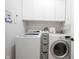 Efficient laundry room featuring a washer, dryer, storage cabinets, and ample counter space for folding at 15591 Heatherbank Dr, Westfield, IN 46074