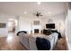 Open concept living room showcasing hardwood floors and comfortable sectional sofa at 15591 Heatherbank Dr, Westfield, IN 46074
