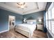 Cozy main bedroom featuring a tray ceiling, hardwood floors, and bedside lamps for a warm ambiance at 15591 Heatherbank Dr, Westfield, IN 46074