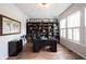 Bright home office featuring a dark wood desk, built-in bookshelves, and elegant white trim at 15591 Heatherbank Dr, Westfield, IN 46074