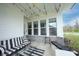 Cozy covered porch featuring modern outdoor furniture and views of the private backyard at 15591 Heatherbank Dr, Westfield, IN 46074