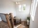 Bright staircase landing with hardwood floors, black railings, and natural light from the windows at 15591 Heatherbank Dr, Westfield, IN 46074