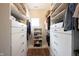 Organized walk-in closet features white shelving, drawers, and ample storage space for clothes and accessories at 15591 Heatherbank Dr, Westfield, IN 46074
