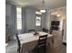 Inviting dining room with a decorative light fixture and views into the living area with a television set at 159 N Lincoln St, Martinsville, IN 46151