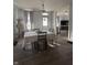Bright dining room with hardwood floors, a chandelier, and a view into the living room with open floor plan at 159 N Lincoln St, Martinsville, IN 46151