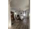 Light-filled dining room showcasing hardwood floors, vintage cabinet, and view into the kitchen area at 159 N Lincoln St, Martinsville, IN 46151