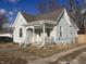 Charming two-story home with light gray siding, white trim, covered front porch, and a well-maintained lawn at 159 N Lincoln St, Martinsville, IN 46151