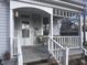 Inviting front porch featuring a white railing, seating, and a decorated entrance door with the house number at 159 N Lincoln St, Martinsville, IN 46151