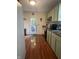 Cozy kitchen with light-colored cabinets and wood-look floors, leading to an outdoor entrance and providing ample counter space at 159 N Lincoln St, Martinsville, IN 46151