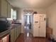 Functional kitchen space featuring ample counter space, a refrigerator, and a view towards the dining area at 159 N Lincoln St, Martinsville, IN 46151