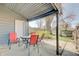 Covered back porch with furniture and view of fenced in back yard at 1614 S Talbott St, Indianapolis, IN 46225