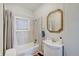 Bathroom with shower and tub combination, tiled walls, and vanity with modern mirror at 1614 S Talbott St, Indianapolis, IN 46225