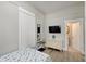 Neutral bedroom with white walls, bedside furniture, and a view of an adjacent bathroom at 1614 S Talbott St, Indianapolis, IN 46225