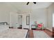Bright bedroom features closet, storage, desk and chair and is decorated with light walls and dark wood floors at 1614 S Talbott St, Indianapolis, IN 46225
