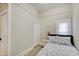 Neutral bedroom features all white walls and a bed with an adjacent bedside table and lamp at 1614 S Talbott St, Indianapolis, IN 46225