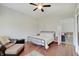 Bright bedroom features ceiling fan, dark wood floors, and doorway to adjacent room with seating and foosball table at 1614 S Talbott St, Indianapolis, IN 46225