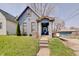 Charming bungalow-style home with blue siding, covered porch, and well-maintained lawn at 1614 S Talbott St, Indianapolis, IN 46225