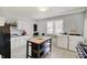 Functional kitchen with white cabinetry, a central island, and modern appliances at 1614 S Talbott St, Indianapolis, IN 46225