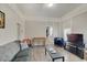 Inviting living room featuring wood-look flooring, comfortable seating, and abundant natural light at 1614 S Talbott St, Indianapolis, IN 46225
