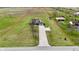 Expansive aerial view of property featuring a well-kept lawn, long drive, and neighboring land at 1687 E 600 N, Whiteland, IN 46184