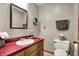 Traditional bathroom featuring wood vanity, floral decor, and neutral color scheme at 1687 E 600 N, Whiteland, IN 46184