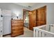 Cozy bedroom featuring a wood dresser, open closet space and neutral decor at 1687 E 600 N, Whiteland, IN 46184