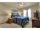 Comfortable bedroom with a plush blue quilt, ceiling fan and natural light at 1687 E 600 N, Whiteland, IN 46184
