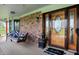 Inviting front porch with brick accents, cozy swing, and a decorative front door at 1687 E 600 N, Whiteland, IN 46184