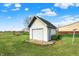 A one car detached garage featuring vinyl siding with landscaping on a well manicured lawn at 1687 E 600 N, Whiteland, IN 46184