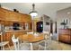 Cozy eat-in kitchen featuring warm wood cabinets, tile floor, and modern appliances at 1687 E 600 N, Whiteland, IN 46184