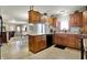 Traditional kitchen with wood cabinets, black appliances, breakfast bar and views of other living spaces at 1687 E 600 N, Whiteland, IN 46184