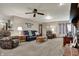 Inviting living area with comfortable furniture, a ceiling fan, and bright lighting at 1687 E 600 N, Whiteland, IN 46184