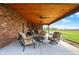 An open patio with stained wood ceiling, ceiling fans, and comfortable seating featuring a view of the lawn at 1687 E 600 N, Whiteland, IN 46184