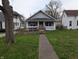 Single-story house with a light-colored exterior, front porch, and accessible ramp leading to the entrance at 1830 Nichol Ave, Anderson, IN 46016