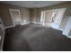 A cozy living room with carpeted floors and a doorway that opens to the next room, perfect for relaxation at 1830 Nichol Ave, Anderson, IN 46016