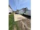Backyard featuring a large driveway, grass and an access door to the home at 2111 Central Ave, Anderson, IN 46016
