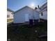 Backyard features a door to the home, trash cans and grass at 2111 Central Ave, Anderson, IN 46016