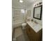 Bright bathroom featuring a shower-tub combo, modern vanity with white marble top, and neutral decor at 2111 Central Ave, Anderson, IN 46016