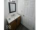 Bathroom features a modern vanity with marble top, wood cabinets, and updated mirror at 2111 Central Ave, Anderson, IN 46016