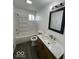 Updated bathroom with modern vanity, tub-shower combo, and sleek lighting at 2111 Central Ave, Anderson, IN 46016